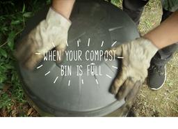 a hand placing a lid to close up a compost bin