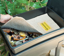 Rectangle worm blanket covers a bin filled with organic materials